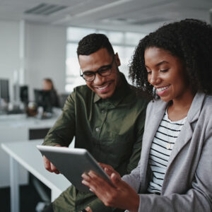 Male and female looking at an ipad