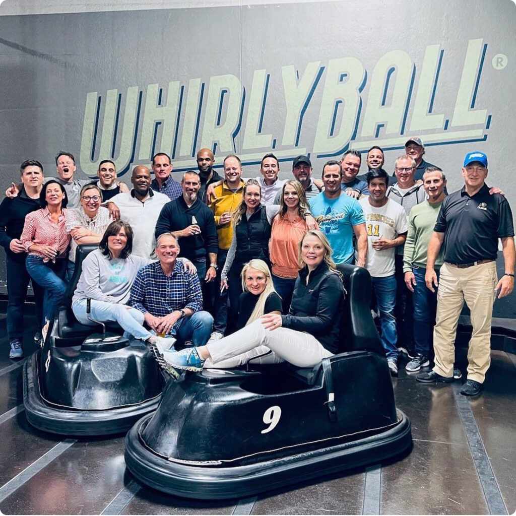 Acadia team members posing for a group photo at Whirly Ball. 